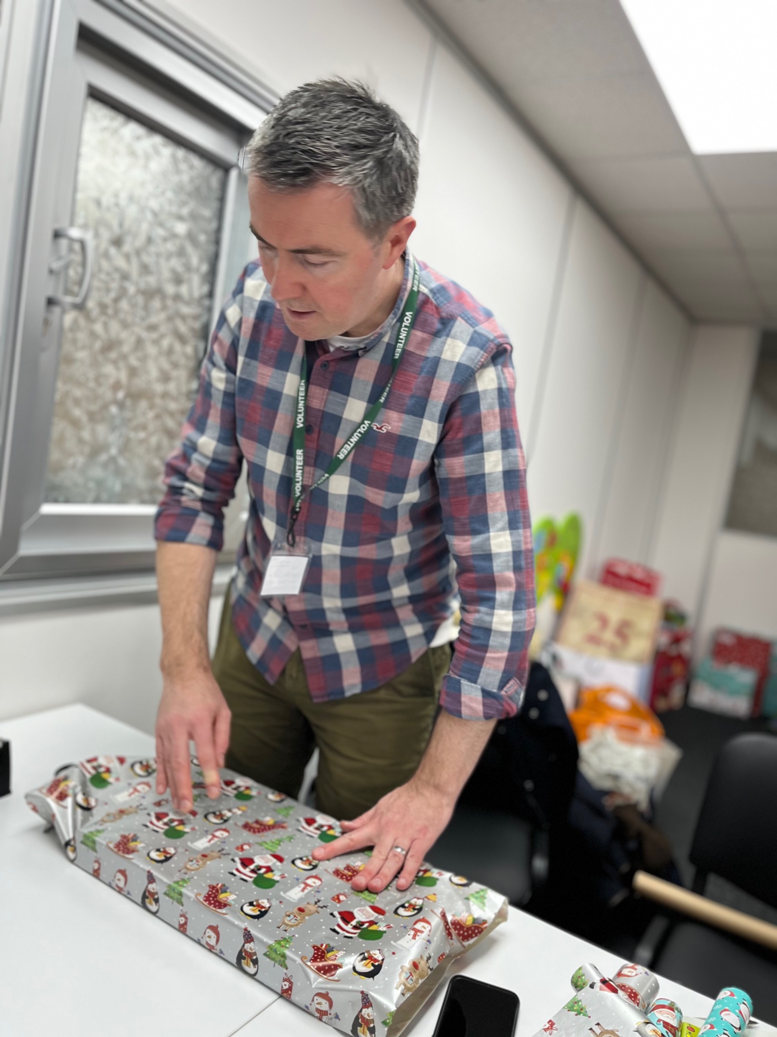 Corporate volunteers help us every year to sort and wrap donated gifts for children who otherwise might not have anything to open on Christmas day